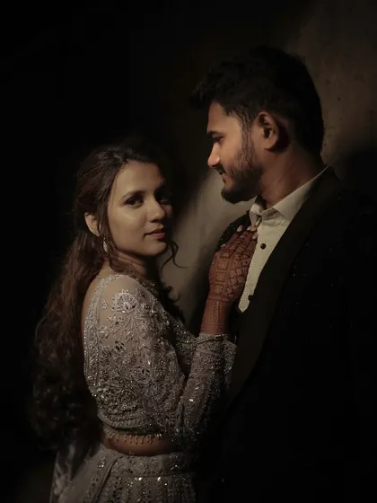 A moody and dramatic portrait of a couple, using low-key lighting to create a sense of intimacy and mystery.