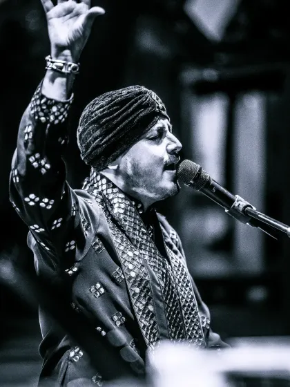 Our lead vocalist, lost in a moment of devotion during the 'Sufi meets Bhajan' performance. The black and white tones capture the timelessness of the music.