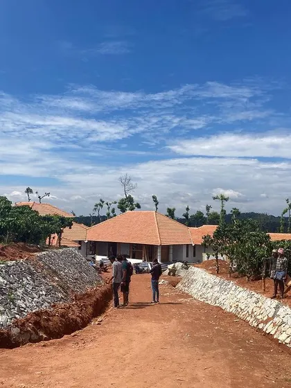 An estate villa under construction in a coffee estate in Chickmagalore. The design uses a series of sloping roofs and is set against the backdrop of the Western Ghats.