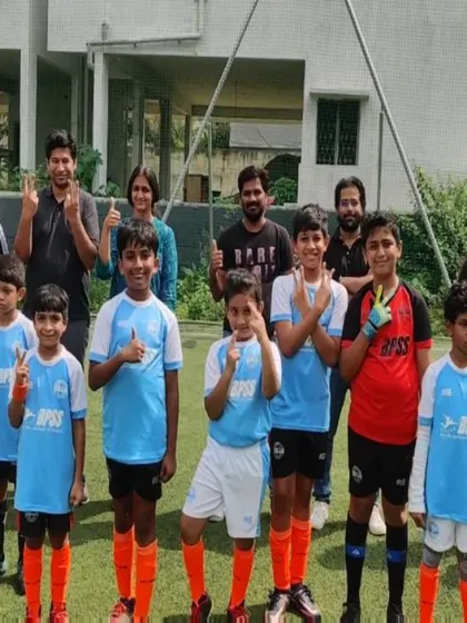 A team of our junior players giving a thumbs-up with their parents. The positive energy is contagious.