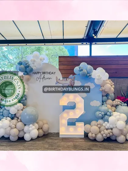 A wider view of the airplane party, showing the full balloon arrangement and the light-up number '2'.