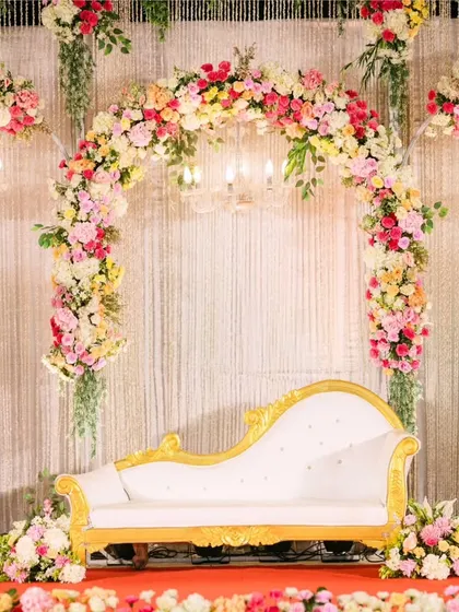 A closer look at the reception stage for Melvin and Marilyn. The elegant chaise lounge, floral arches, and candle-lit accents created a romantic and sophisticated focal point for the evening.
