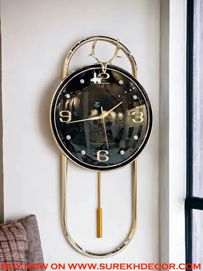 With its deep black face and contrasting gold details, this imported pendulum clock exudes sophistication. The elegant deer-head crest adds a unique design element, making it a perfect statement piece for a refined living space.