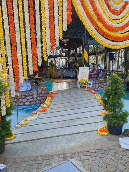 A traditional entrance decorated with hanging marigold garlands, creating a festive and welcoming atmosphere.
