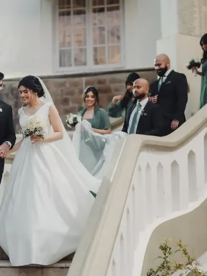 Another shot of their joyful exit. Her entire look, from the gown to the hair, is the picture of classic bridal elegance.