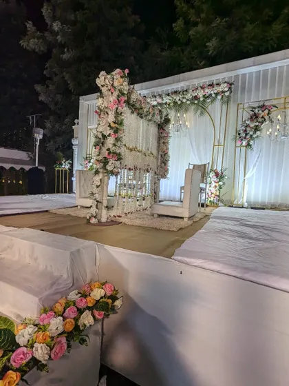 A side view of the large Nikah stage, showing the scale of the setup and the beautiful floral arrangements that frame the ceremony space.