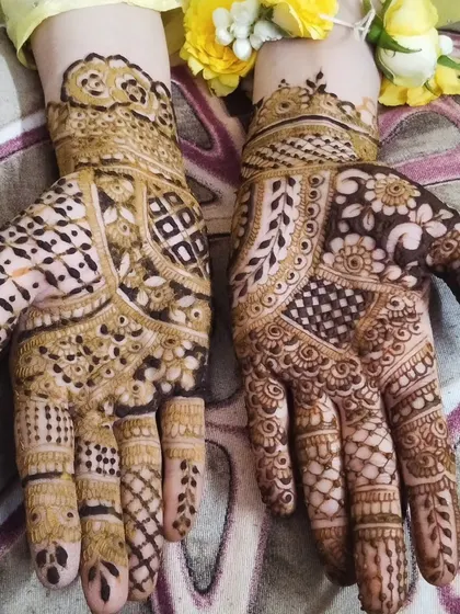 A lovely bridesmaid design with geometric patterns and floral details, accented with fresh yellow flowers. This is a perfect look for a haldi ceremony or spring wedding.