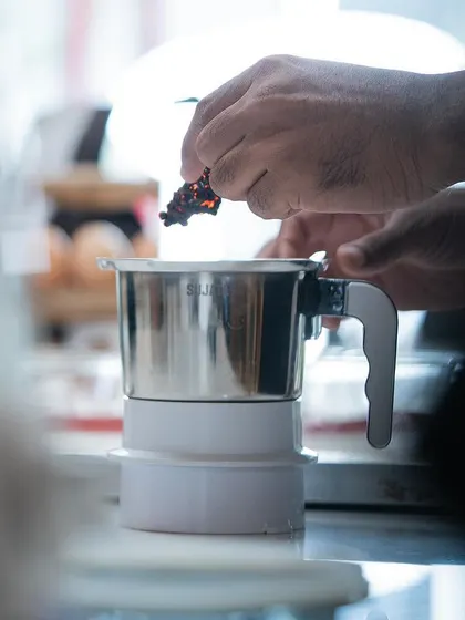 Blending spices into a chocolate base. We encourage students to explore unique flavor combinations and develop their own signature creations.
