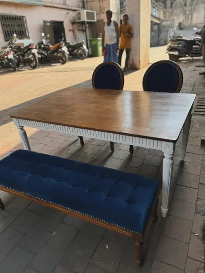 Another view of the blue velvet dining bench paired with a two-toned table.