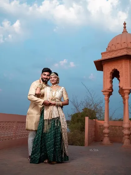 Using the beautiful sky as a backdrop, this portrait on the palace terrace has a majestic feel. The couple's pose is elegant and timeless, fitting the royal theme.