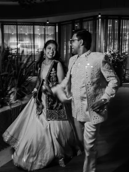 A timeless black and white photo of the couple sharing a laugh. The lack of color puts the focus entirely on their expressions and the joyful energy between them.