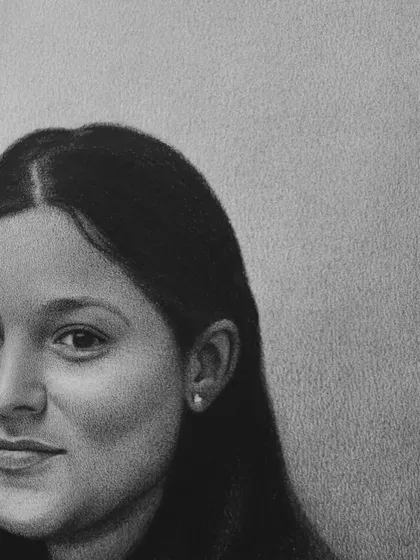 A detailed look at the lady's portrait, highlighting the soft texture of her hair and her serene smile.