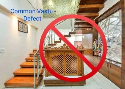 One of the most common and serious Vastu defects is placing a pooja mandir under a staircase. This image clearly shows why this should be avoided, as the staircase creates heavy, negative energy that is unsuitable for a sacred space.
