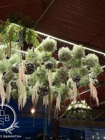 I love playing with ceilings to completely transform a space. This "Disco on the greens" installation combined lush florals with sparkling disco balls for a corporate celebration, proving that any event can have a touch of magic.