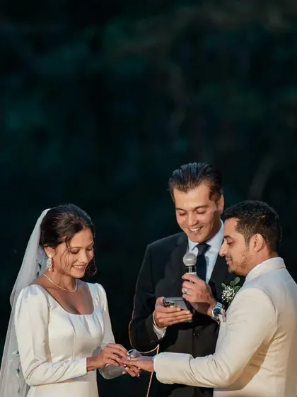 A beautiful ring exchange ceremony during an evening outdoor wedding. I ensure the lighting and ambiance are perfect for these key moments.