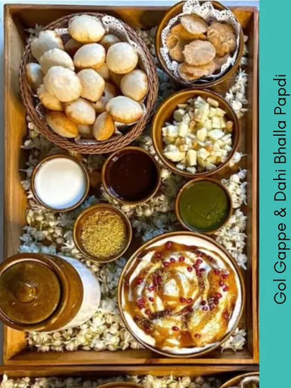 A beautiful chaat platter from our summer feast menu. This spread includes everything you need for Gol Gappe and Dahi Bhalla Papdi, laid out with all the chutneys and toppings.