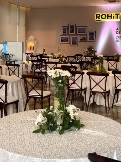 Another view of the corporate event setup, highlighting the beautiful floral centerpieces and the overall sophisticated ambiance I created overnight.