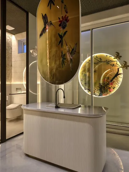 Art becomes a central feature in this bathroom design. A custom-painted glass panel with hummingbirds adds a touch of delicate beauty and color, transforming the vanity area into a unique and personal art installation.
