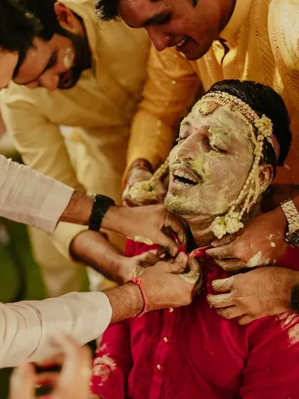 A close-up of the groom's 'Haldi-smothered' face, a classic and fun moment from the ritual.