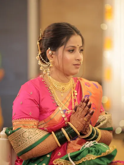 The bride during a quiet moment in her ceremony, her hands joined in prayer.