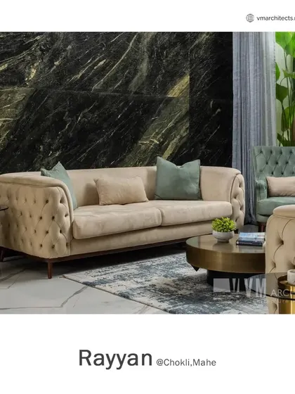 The luxurious tufted sofa in the Rayyan living room, complemented by soft cushions and a modern brass side table, exemplifies my approach to comfortable elegance.