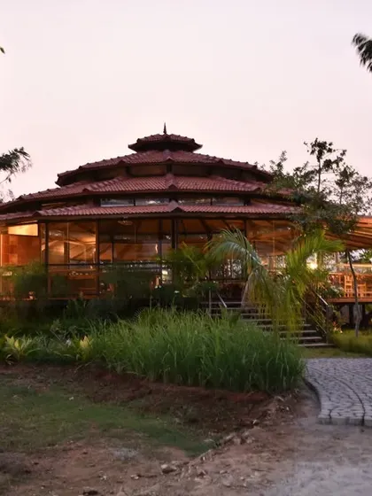 The main dining hall at our Kabini resort, with its iconic circular design, glows warmly at dusk.