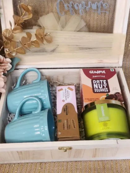 Our collaboration with EKAM also includes this lovely wooden box hamper, filled with their signature scented candle, ceramic mugs, and healthy date nut squares.