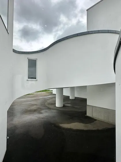 The interplay of curved and straight lines in the building's exterior circulation spaces.