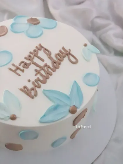 A closer look at the painted floral design on this minimalist cake.