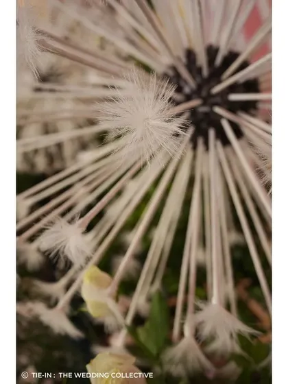 Our commitment to craftsmanship is seen in details like these handmade dandelions for the 'Midsummer Dream' theme. Each element is meticulously created by our in-house team to bring a unique, fantastical vision to life.