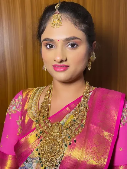 A close-up portrait of the bride, showcasing the flawless base and defined features.