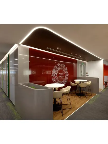 A perspective view of a collaborative corner within the ICICI Bank office, highlighting the "Zero Waste" graphic on the red glass wall. This detail shows how we integrate a company's values directly into the physical workspace design.