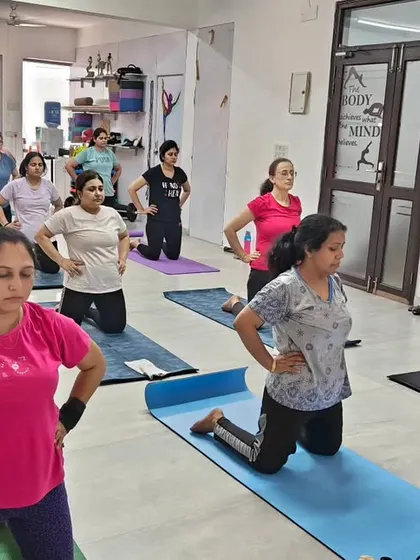 A focused moment during our group yoga class in Gurugram. Students are preparing for Ustrasana (Camel Pose), a powerful heart-opening asana.