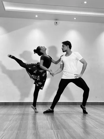 A black and white series featuring a male and female ballet dancer (ballerino and ballerina) practicing partner work. My classes include pas de deux techniques for advanced students.