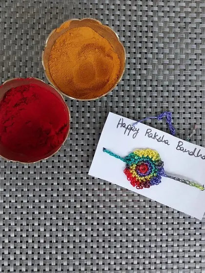 A beautiful rainbow-colored crochet rakhi. This design is always a cheerful and popular choice.