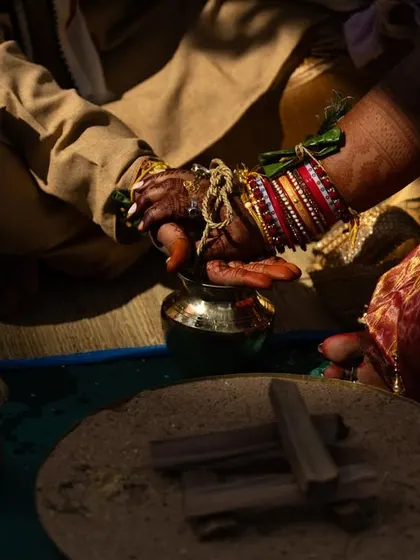 The 'Hatha Ganthi' or tying of the knot, a significant ritual in an Odia wedding. This close-up shot focuses on their hands, symbolizing their eternal bond.