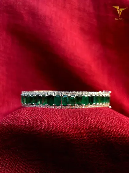 An Evergreen Classic. This sophisticated and stunning emerald and diamond bracelet is the perfect finishing touch for your Diwali gatherings or evening soirees.