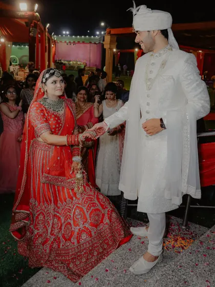 The couple walking hand-in-hand during their wedding ceremony. This is a classic shot that symbolizes the beginning of their journey together.