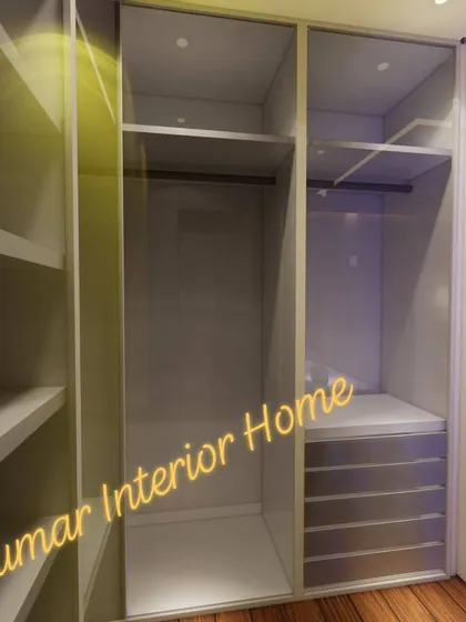 The interior of a sliding wardrobe with glass doors, showing the organized layout of shelves and drawers.