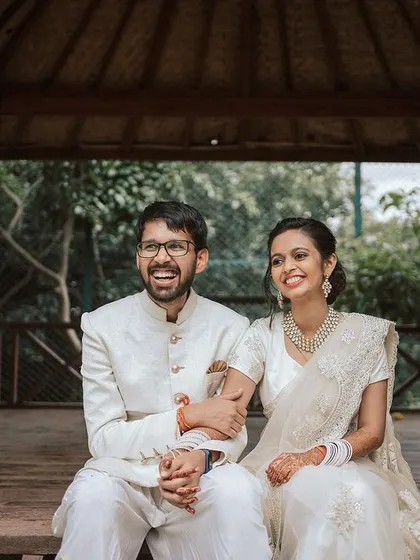 A happy couple shares a laugh in one of our gazebos, a perfect spot for romantic wedding photos.