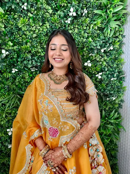 Eyes closed to showcase the soft, golden eyeshadow. This look is all about creating a warm and subtle glow.