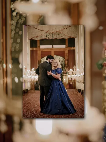 A creative shot of the couple dancing, framed by the beautiful bokeh of the decor.