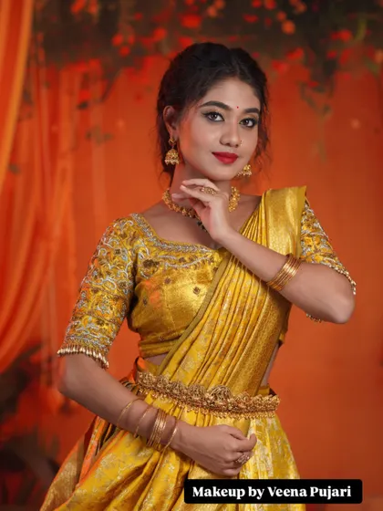 A vision in yellow. This half-saree look is perfect for pre-wedding events, with makeup that is bright, fresh, and celebratory.