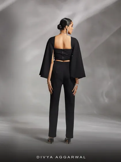 The back of our Ezra co-ord set, showing the clean lines of the sleek trousers and the unique silhouette of the detachable cape sleeves.