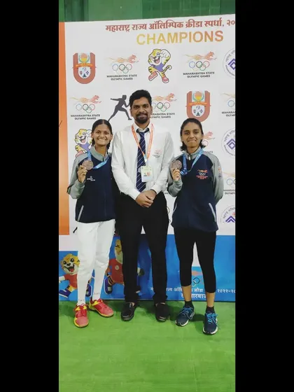 Posing with two of our medalists at the Maharashtra State Olympic Games. Competing in these games is a prestigious opportunity, and their success brings great pride to our club.
