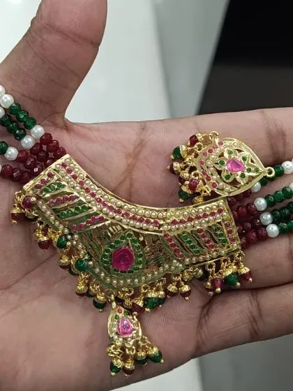 A beautiful Jadau choker with intricate meenakari work in red and green. This is a classic piece of traditional Indian jewellery.