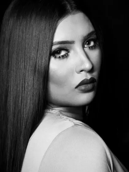 A classic three-quarter pose, showing the sleek hair and bold makeup in this B&W series.