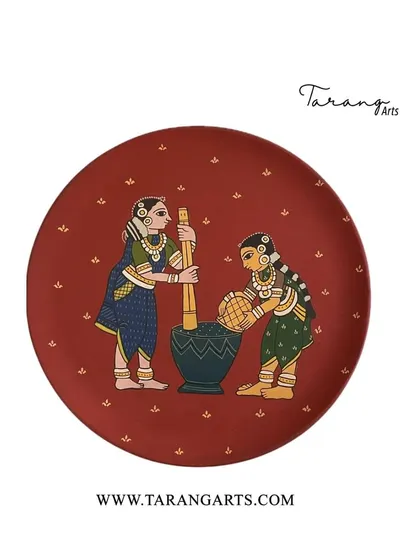 Our hand-painted wooden plates often depict scenes from rural Indian life, celebrating our culture and traditions. This piece shows two women at work, rendered in a beautiful folk art style.