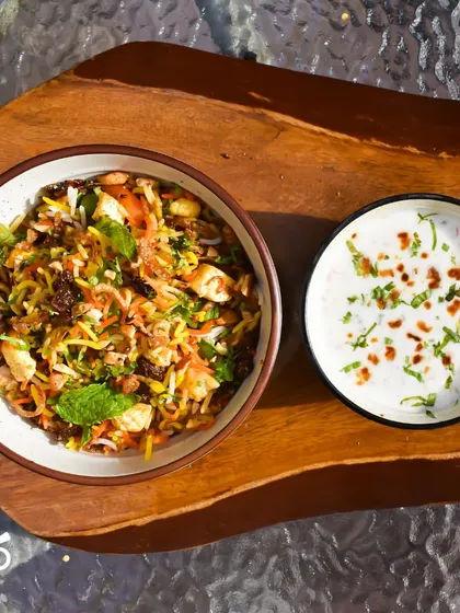 Another beautiful shot of the Nizami Tarkari Pulao, a one-pot wonder that's both comforting and delicious. Served here with a side of cooling raita.