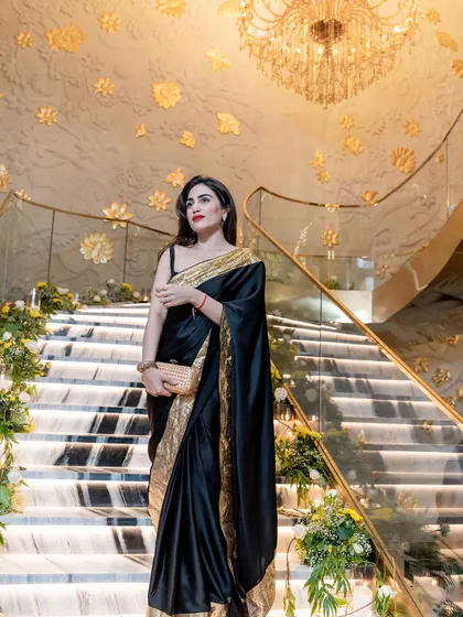 A classic black and gold satin saree I designed. This look is pure elegance, perfect for a formal reception or a glamorous evening event.